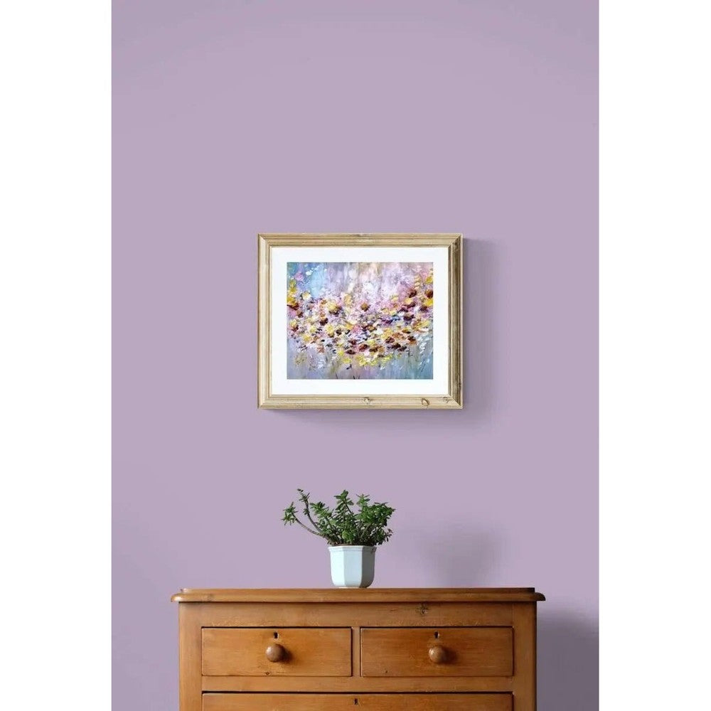 Abstract painting with vibrant splashes of pink, yellow, red, and white resembling a field of flowers against a soft blue and pastel background.
